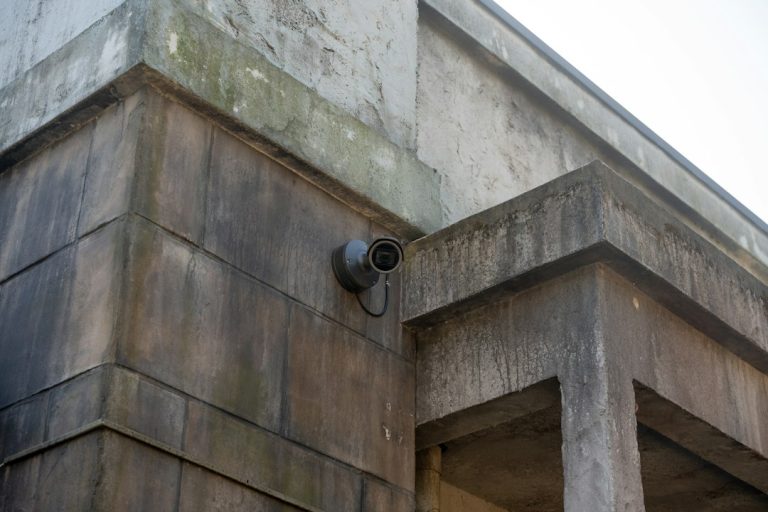 Outdoor surveillance camera mounted on a building wall