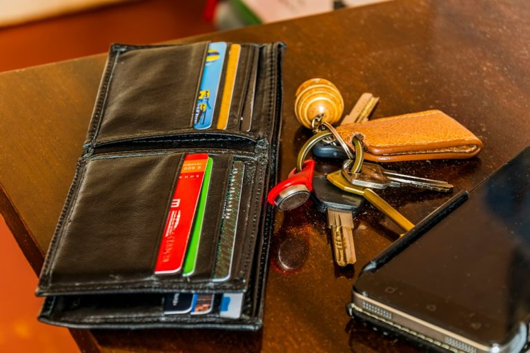 Mobile phone, wallet and keys on a table